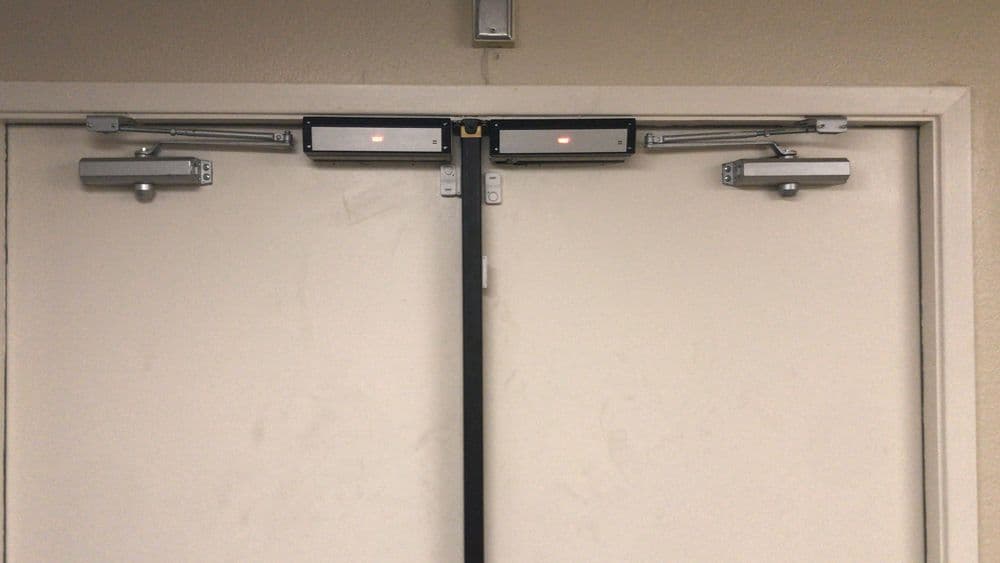 Automated double doors with sensors and safety features in a commercial setting.