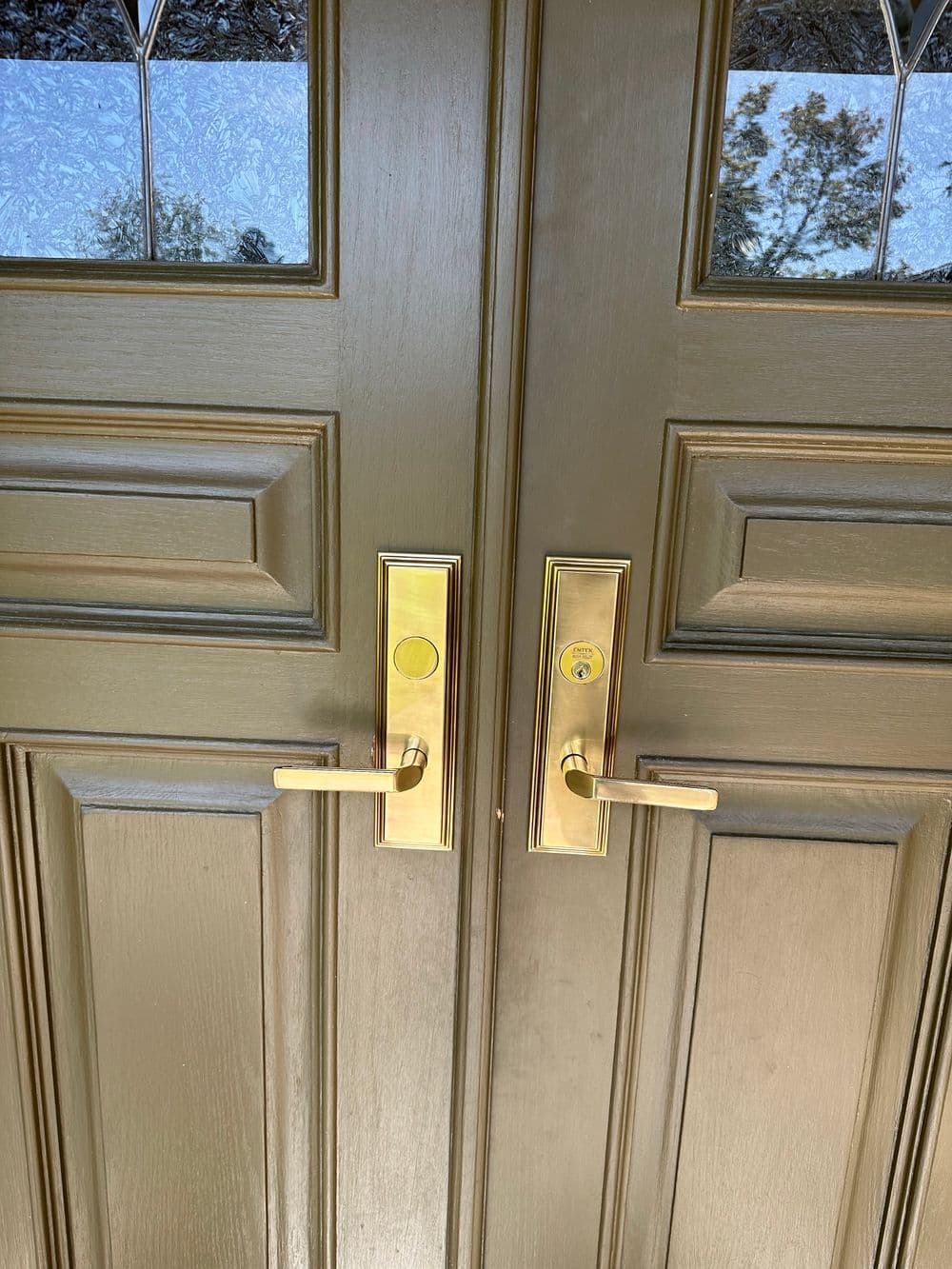 Elegant double doors with gold handles and decorative glass panels.
